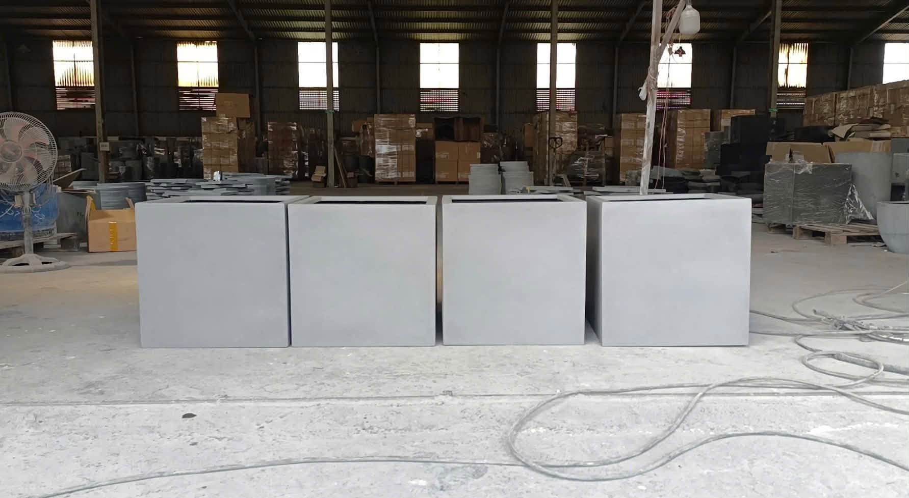 Grey cube fiberstone planters in the Furnio workshop